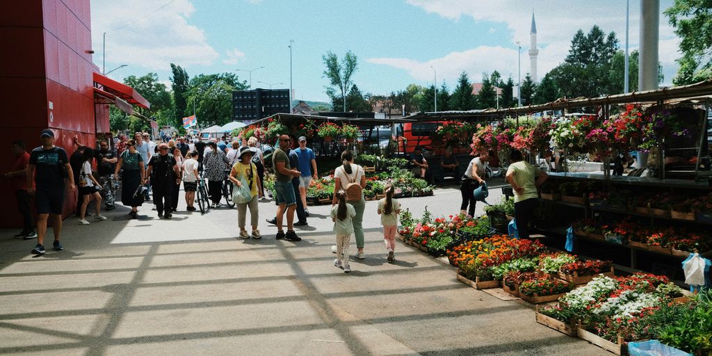 a group of people walking around a market
